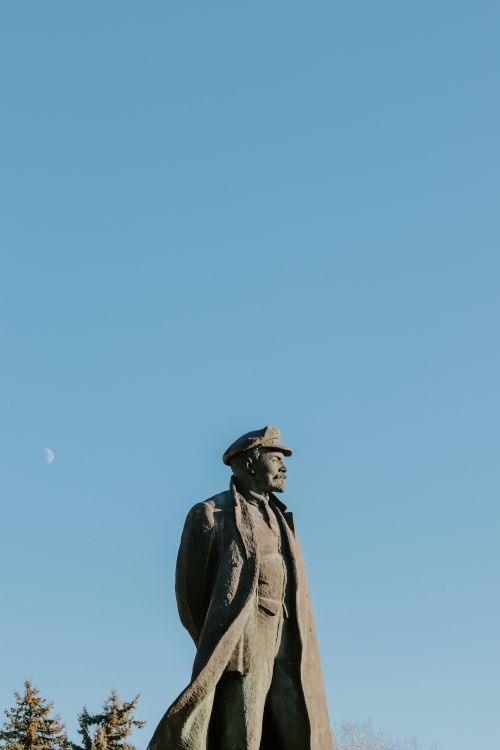 Free A striking monument silhouetted against a blue sky with a visible moon. Stock Photo