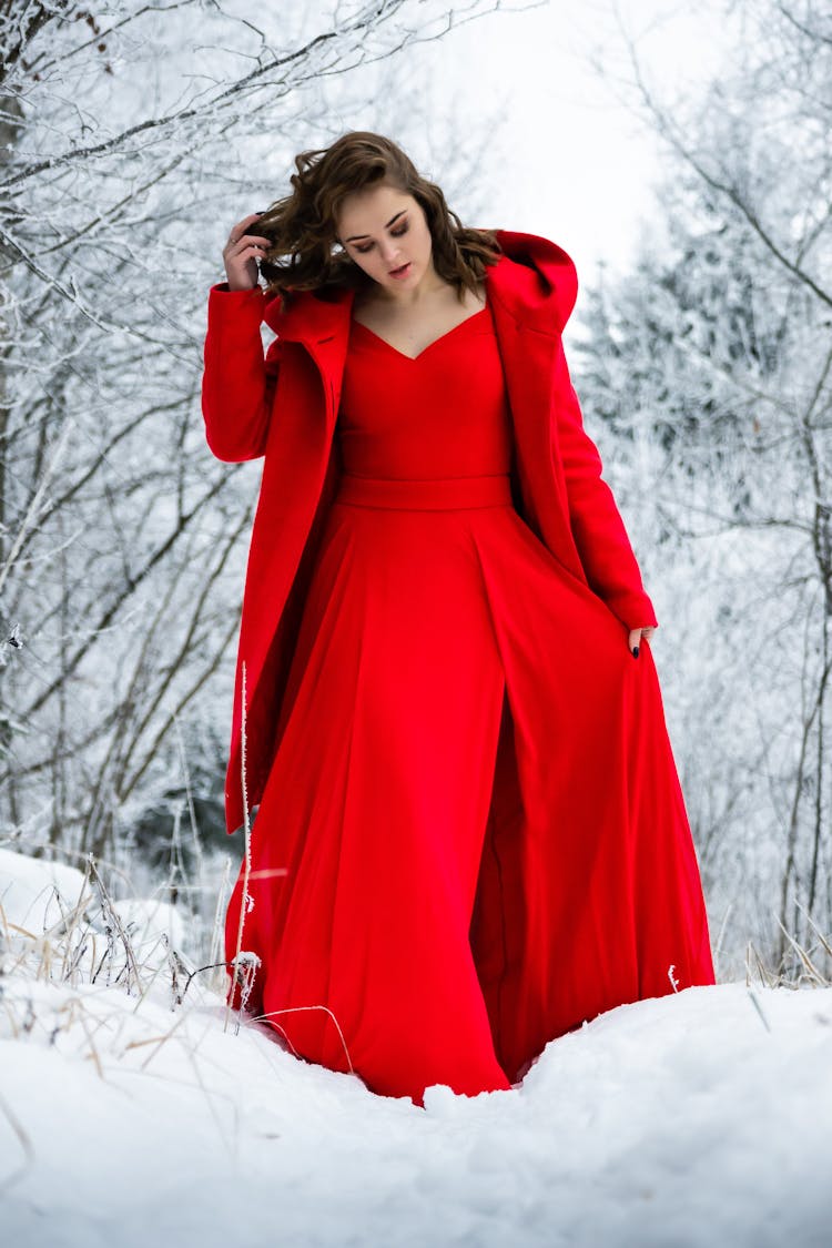 Woman In Red Outfit Walking On Snow