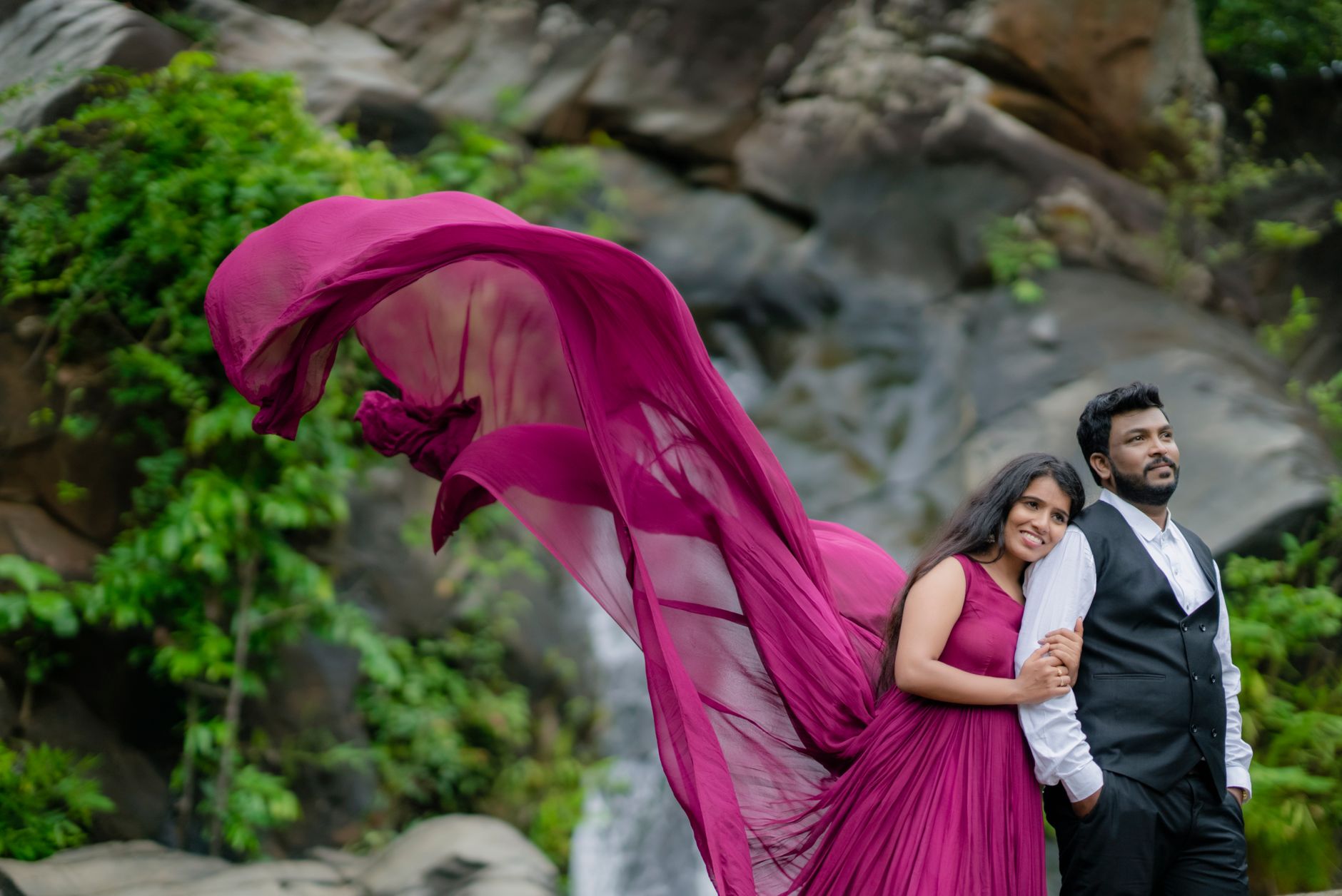 Charming outdoor photo of a couple in love, featuring a purple dress blowing in the wind, exuding romance and joy.