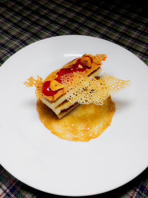 Artistic presentation of a gourmet dish with delicate garnishes captured at a top-down angle.