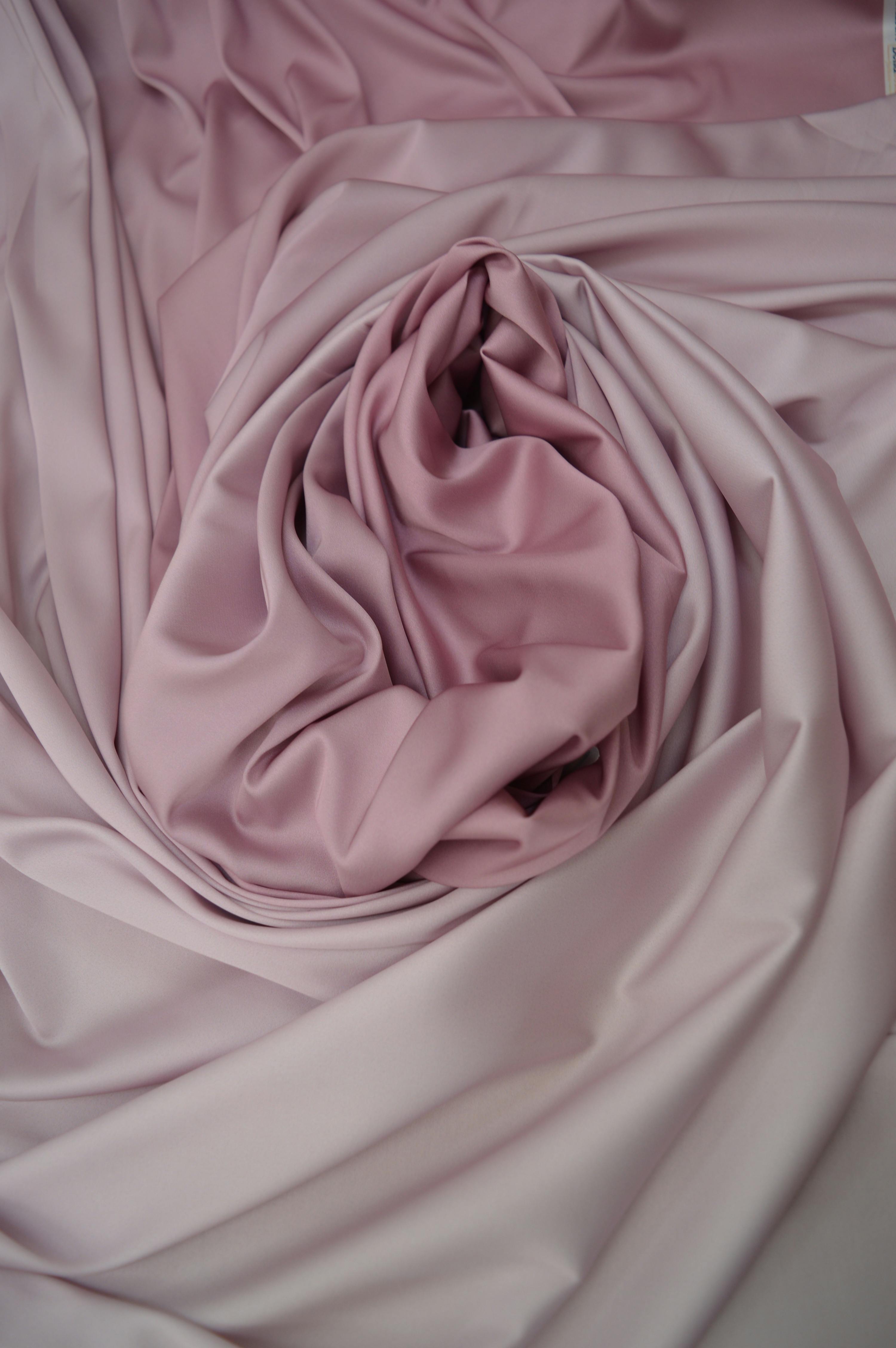 A supplier presenting fabric swatches and samples to a wholesale buyer, symbolizing partnership and selection