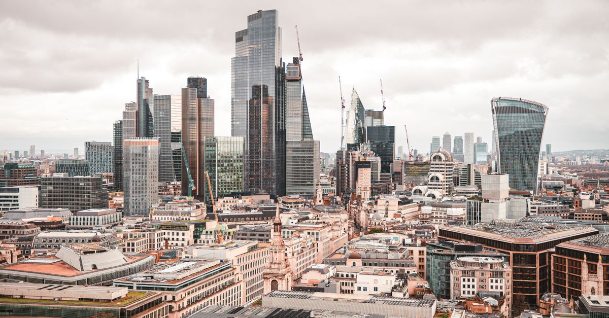A stunning aerial view of London's modern skyscrapers under overcast skies, showcasing its architectural marvels.