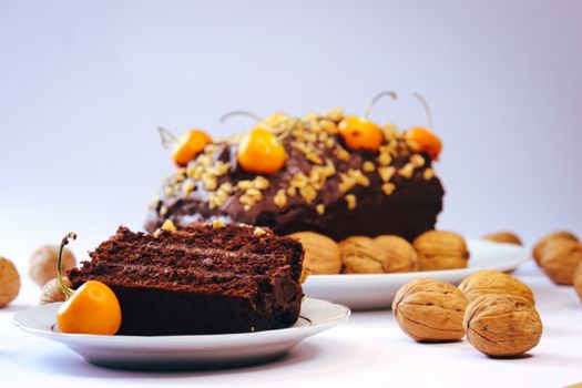Close-up of chocolate cake slice with walnuts and cherries, perfect for dessert lovers.