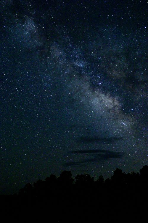 Free A breathtaking view of the Milky Way galaxy stretching across a star-filled night sky. Stock Photo