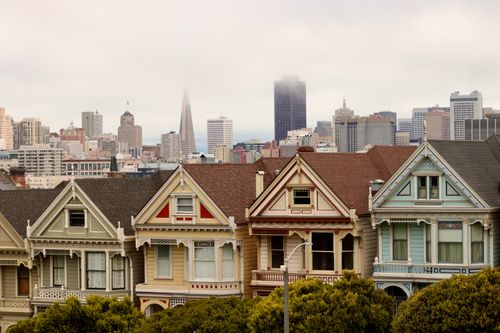 Free Iconic Painted Ladies in San Francisco with city skyline and fog. Stock Photo