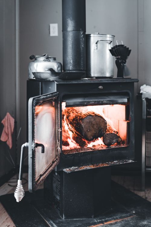 Free A warm wood-burning stove adds a cozy touch to an indoor space, perfect for cold seasons. Stock Photo