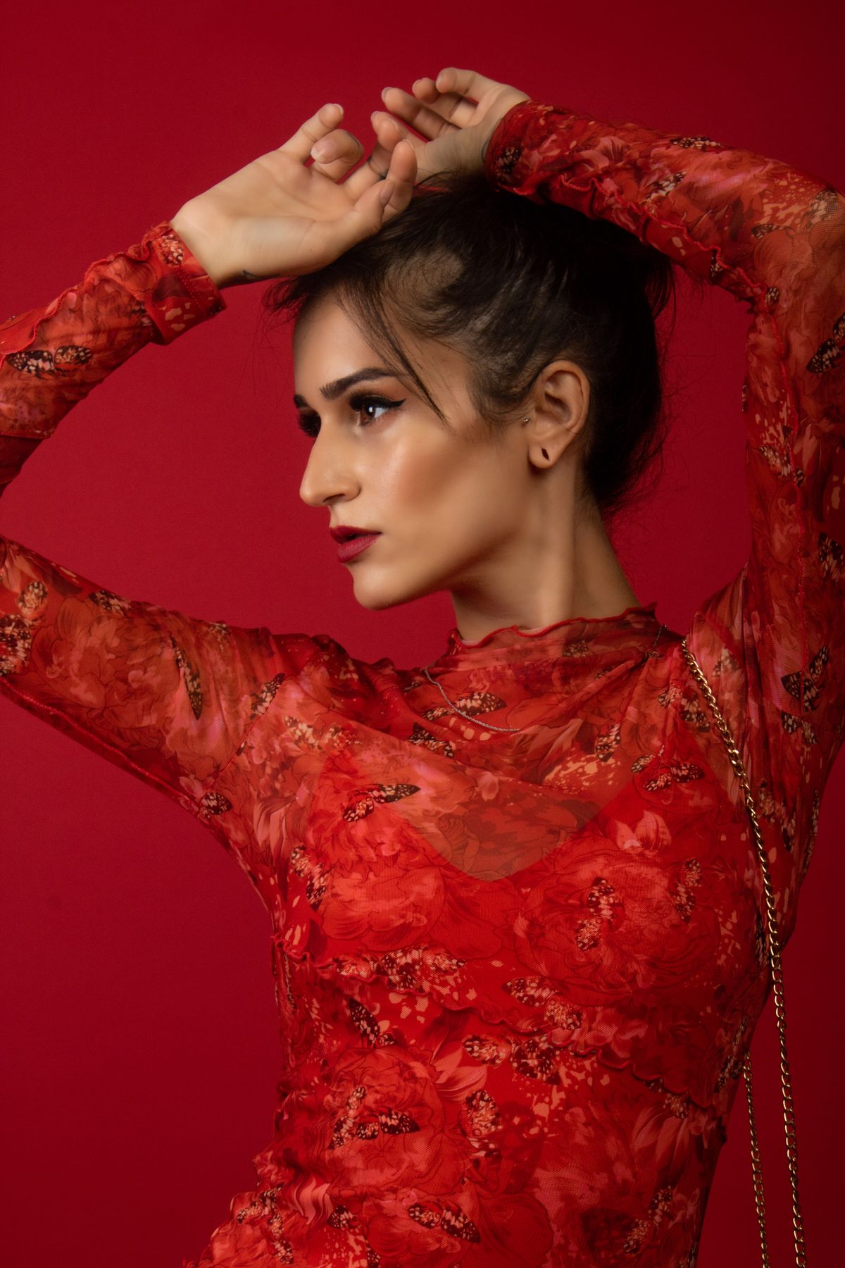 A woman posing in red clothes — styling the red dress with restraint