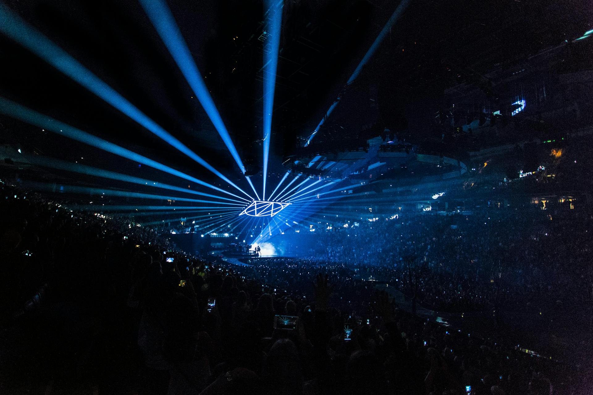 People on Arena With Lighted Stage