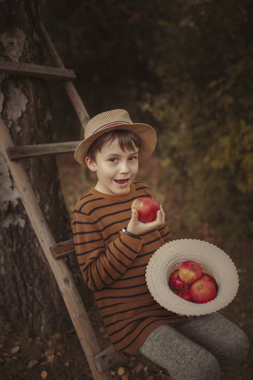 Boy Enjoying Fresh Harvest of Apples