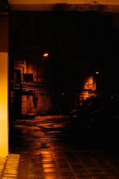 Dramatic street scene in a dimly lit Moscow alleyway, showcasing wet cobblestones and atmospheric lighting.