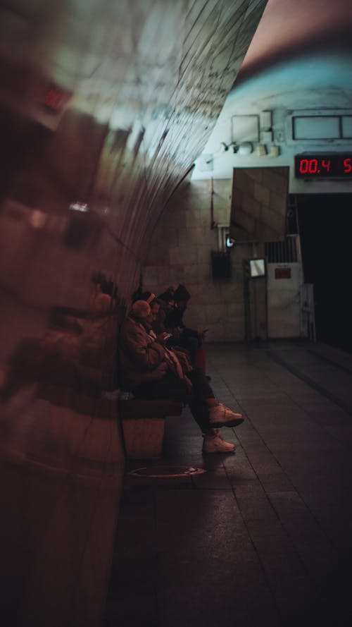 People Sitting at the Subway Station and Waiting for the Train 