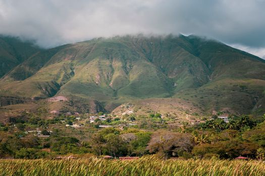 Explore Merida's picturesque and verdant hills under a cloudy sky, featuring rural landscapes.