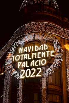 Bright Christmas decorations light up a city building, celebrating the holiday season at night.