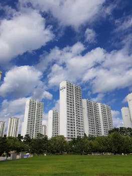 Tall residential skyscrapers against a clear blue sky in Yongin, South Korea.