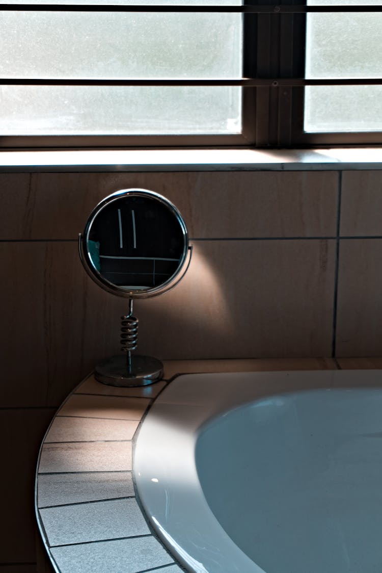 Mirror On The Edge Of A Bathtub