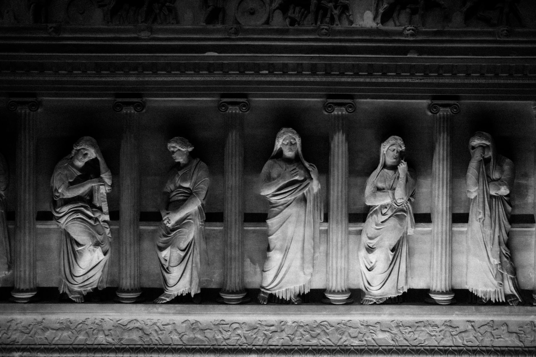 Black and white photo of ancient sarcophagus relief with women figures in Istanbul, Turkey.