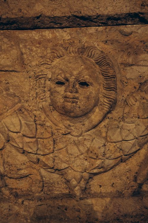 Free Detailed stone bas relief depicting a face at Istanbul Archaeology Museum in Turkey. Stock Photo