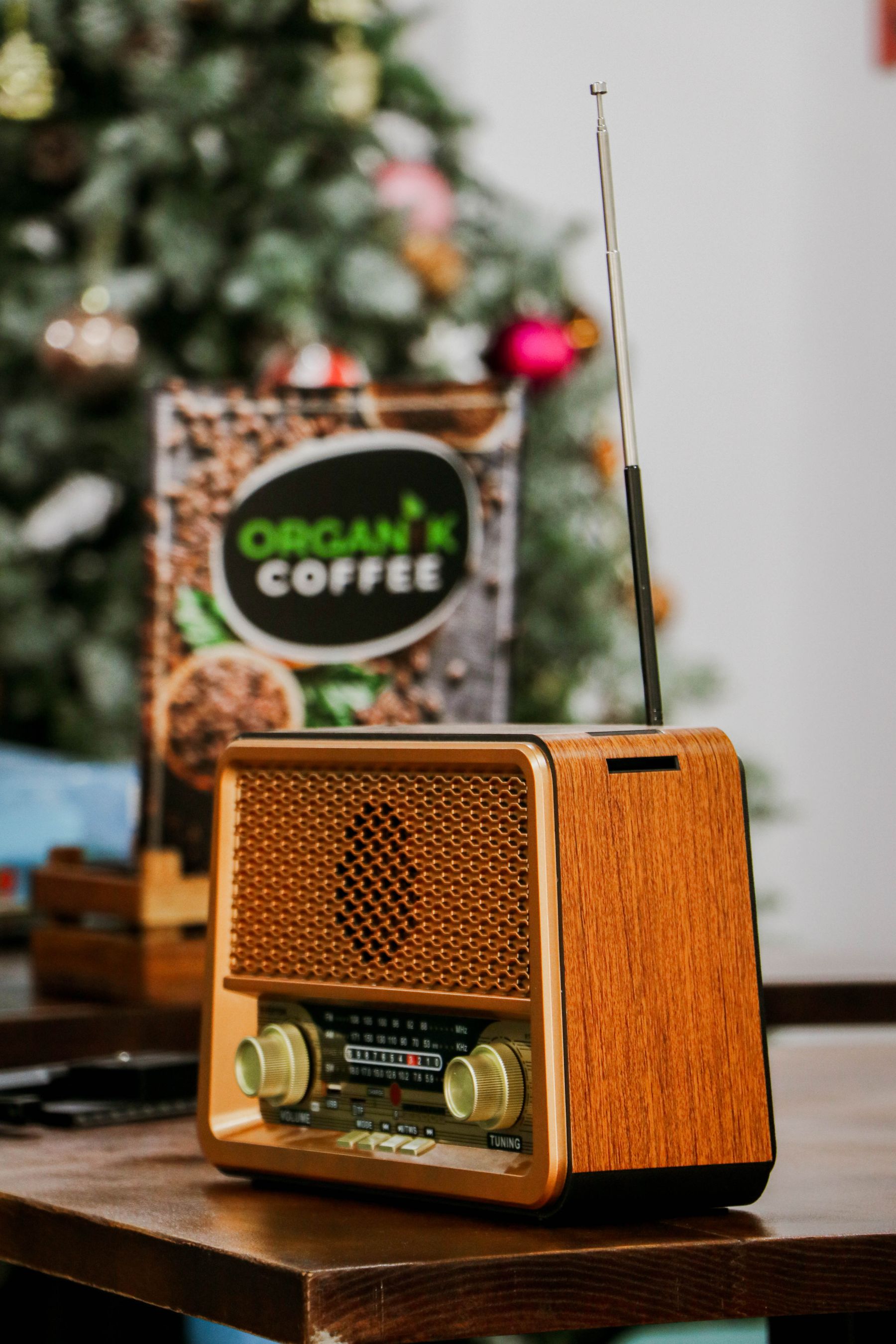 Vintage radio beside a lit Christmas tree in a nostalgic interior