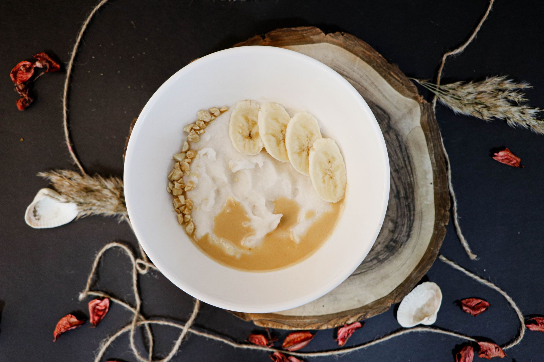 Banana pudding milkshake with fresh bananas and wafers on the side