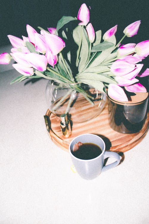 Free Mug of Tea by Tray with Tulips in Vase Stock Photo