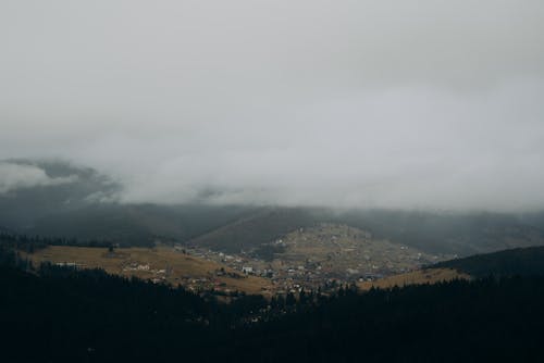 Foto profissional grátis de aldeia de montanha, árvores, céu branco