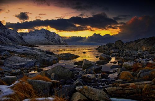 Free Captivating winter sunset over the rocky coast of Lofoten Islands, Norway, showcasing a serene and ethereal landscape. Stock Photo