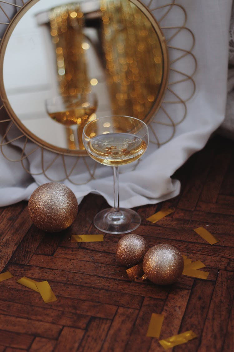 A Glass Of White Wine And Glitter Christmas Baubles 