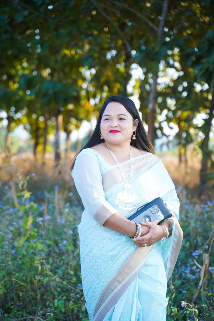 Woman In A White Dress On A Field 