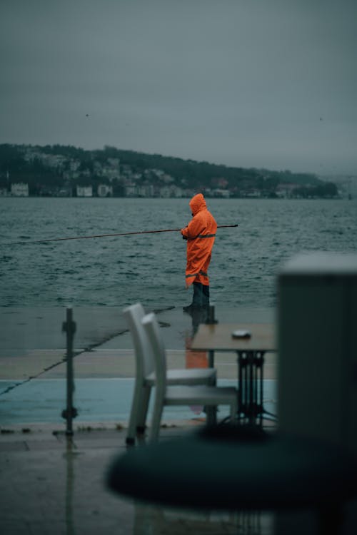 Fisherman Wearing an Orange Raincoat