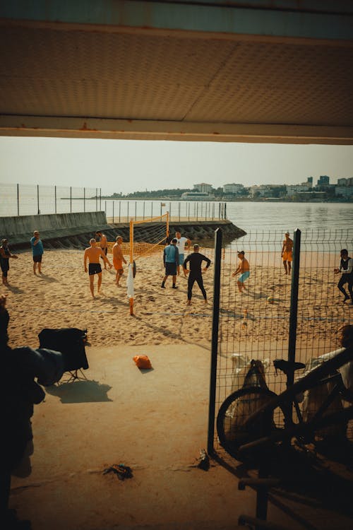 Men Playing Beach Volleyball 