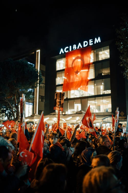 A Crowd Celebrating on the Street and Waving Turkish Flags 