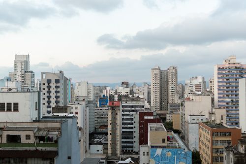 Free Aerial view of São Paulo's skyline with diverse urban architecture under cloudy skies. Stock Photo