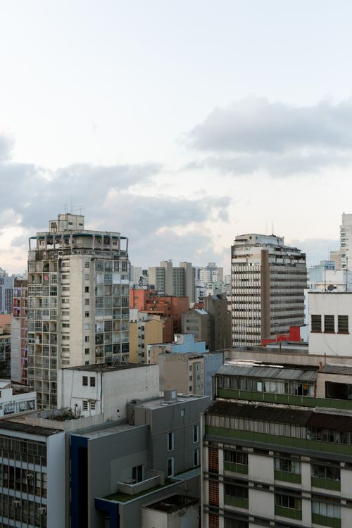 Free Elevated view of São Paulo's urban skyline with modern high-rise buildings under a cloudy sky. Stock Photo