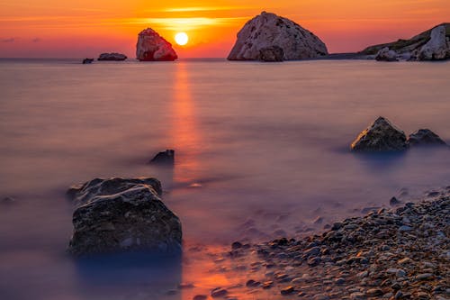 Long-Exposure Photography of Rocky Shore during Sunset