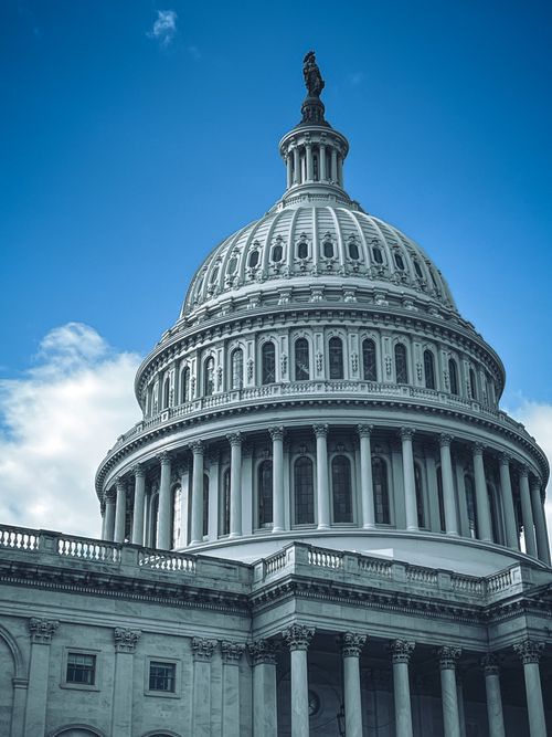 Free A striking view of the iconic United States Capitol dome against a clear blue sky. Stock Photo