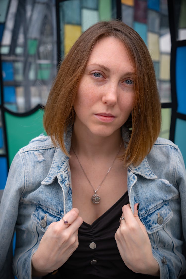 Woman Holding The Collar Of Her Jean Jacket