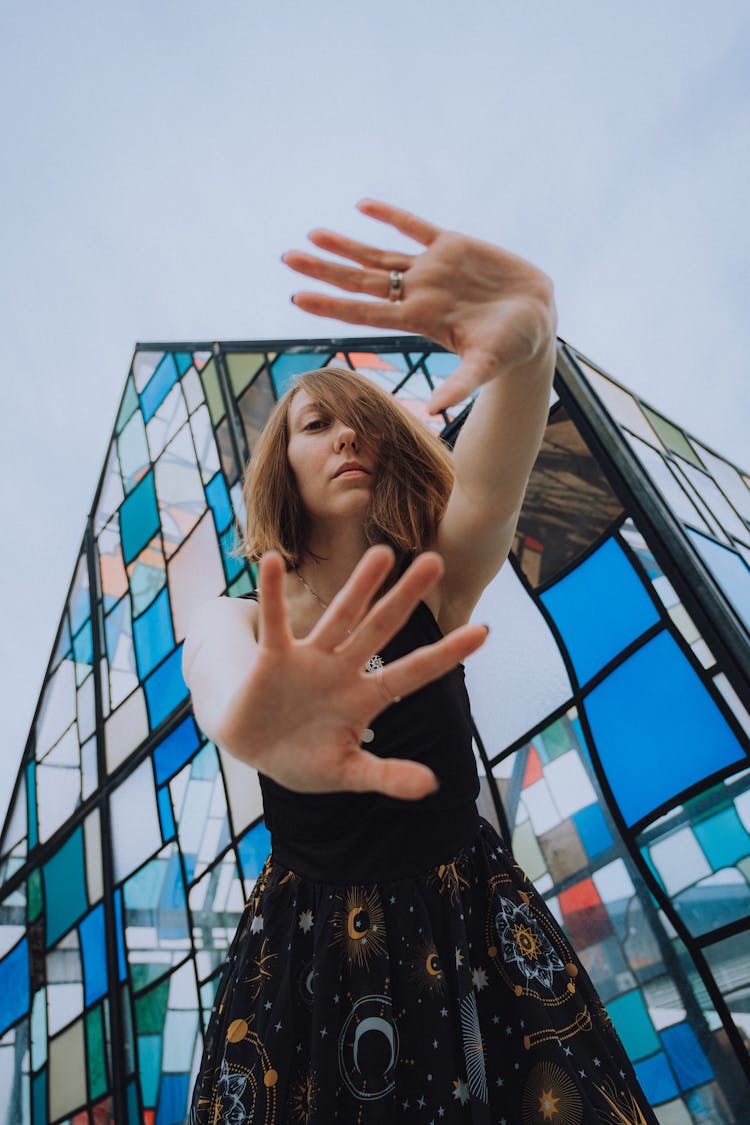 A Woman Posing Near A Stained Glass Building