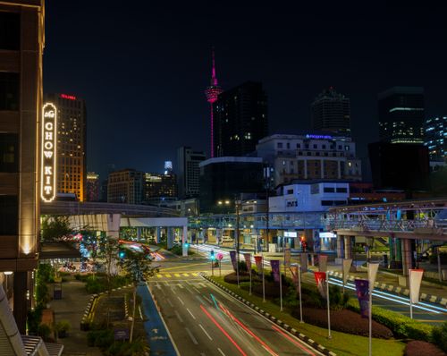 Free Dynamic view of Kuala Lumpur's cityscape at night featuring illuminated streets and modern architecture. Stock Photo