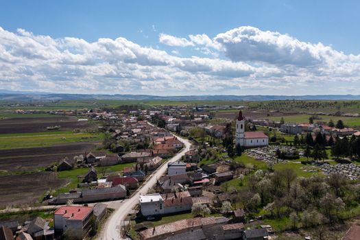 Beautiful aerial panorama of Chanava village, showcasing fields and architecture under a bright sky.
