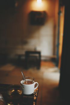 Warm, intimate indoor scene featuring a coffee mug on a rustic table.