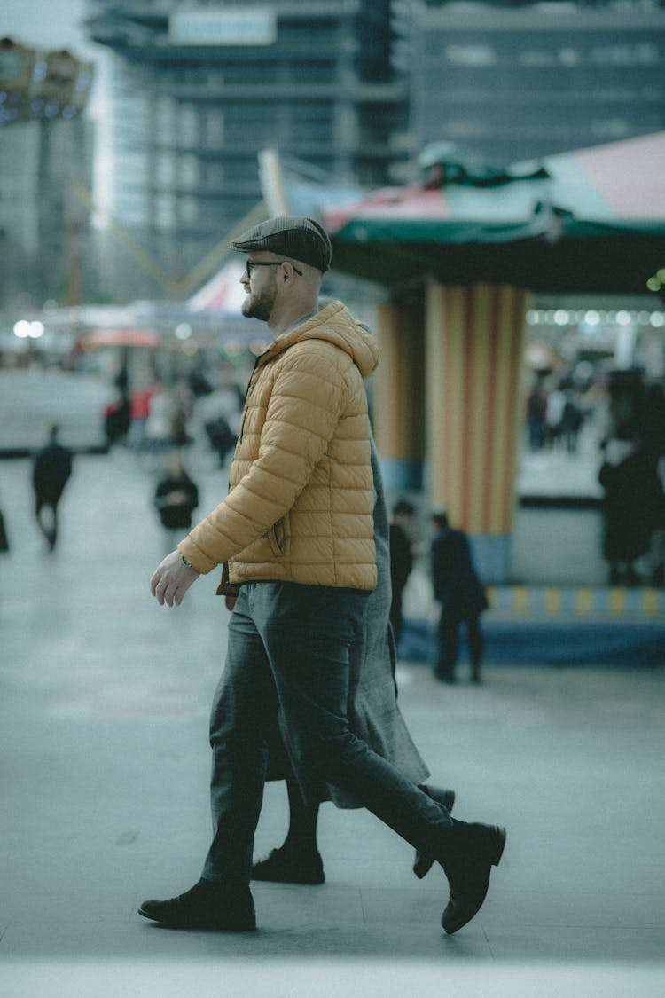 Man And Woman Walking On A Sidewalk 