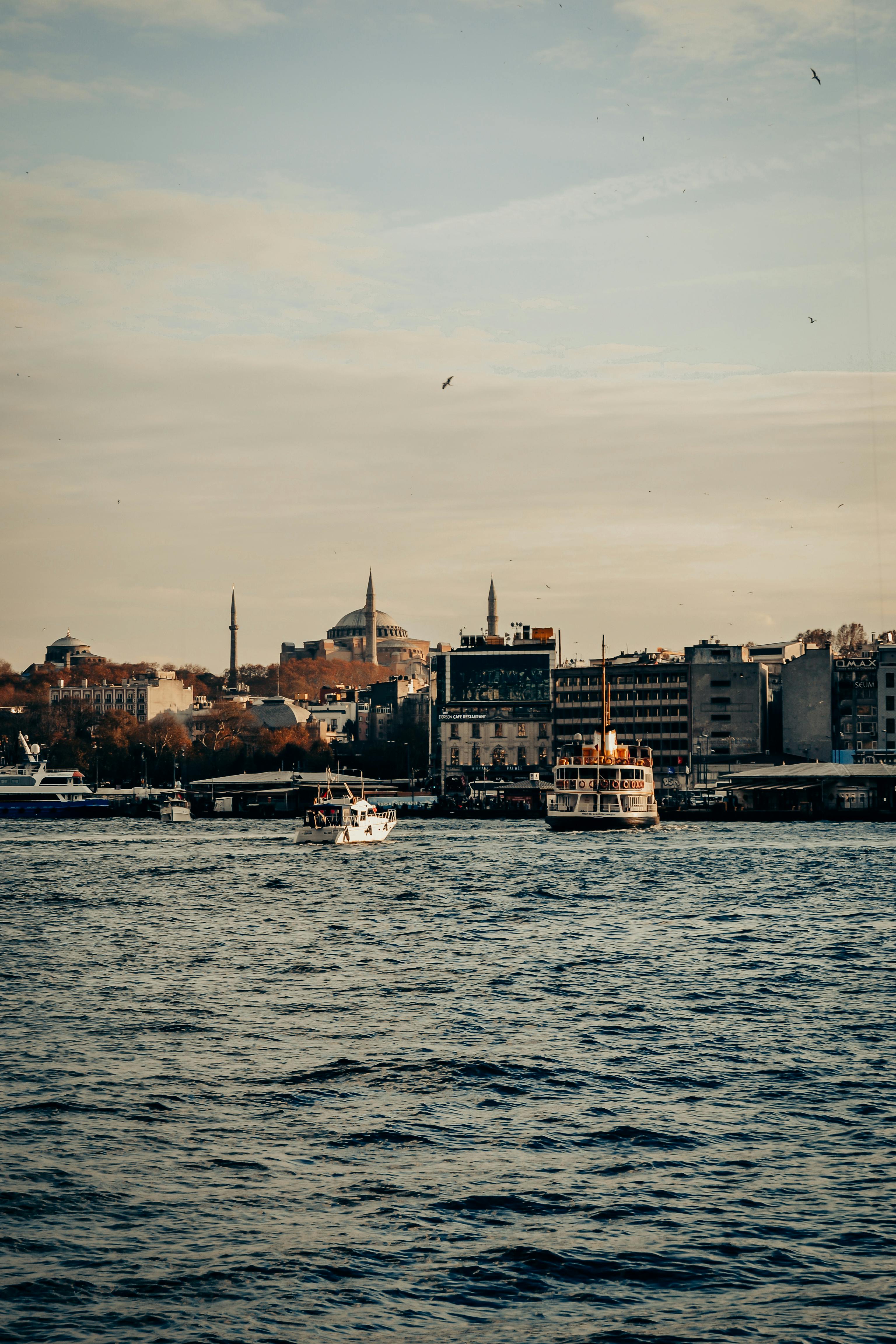 Ferryboats sailing on the Bosphorus with Istanbul's skyline in the background.
