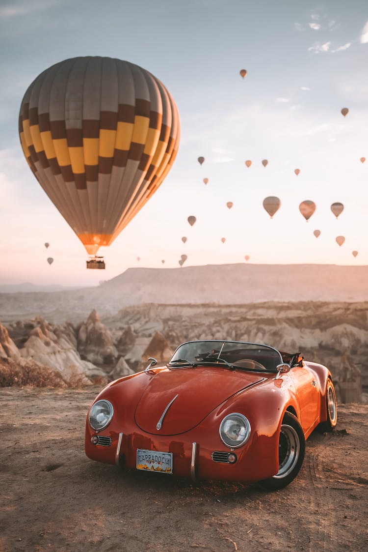 Hot Air Balloons And Car On Desert