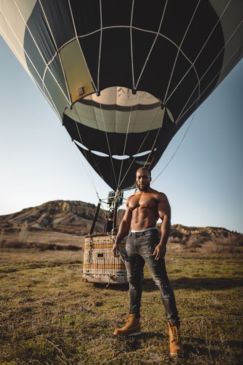 Topless Man Posing near Balloon