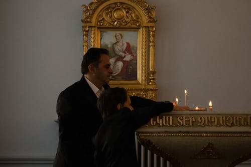 Man and Boy Lighting Candles in an Armenian Church