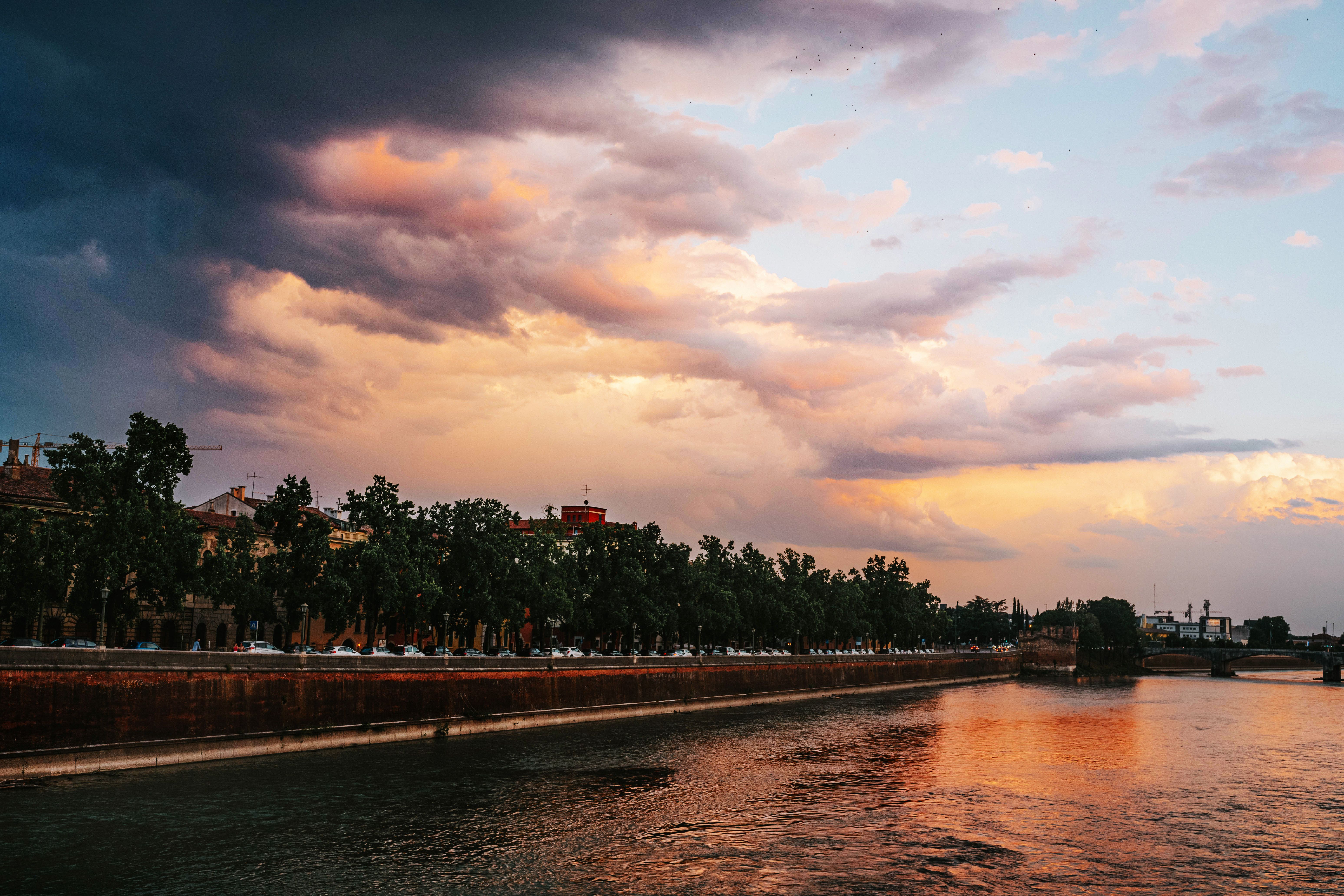 Dramatic Sky at Sunset over City River · Free Stock Photo