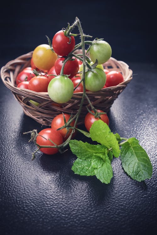 Free Photo of Tomatoes on Woven Basket Stock Photo