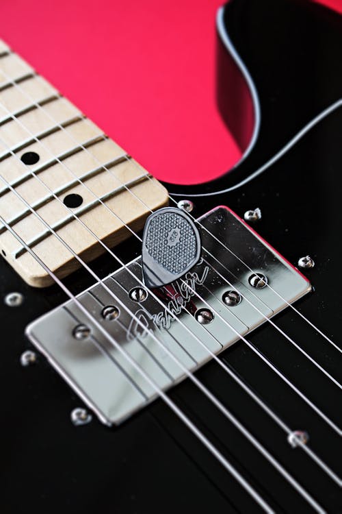 A Close-Up Shot of a Guitar Pick on an Electric Guitar