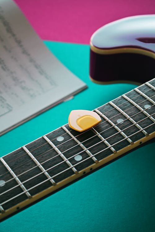 Free A Guitar Pick on the Strings of an Electric Guitar Stock Photo