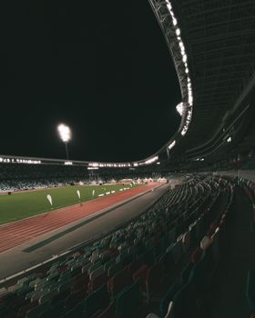 Stunning nighttime view of a well-lit stadium in Minsk, showcasing its architecture under lights.